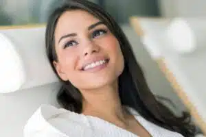 Woman smiling confidently after receiving Jeuveau treatment to smooth facial wrinkles and refresh appearance