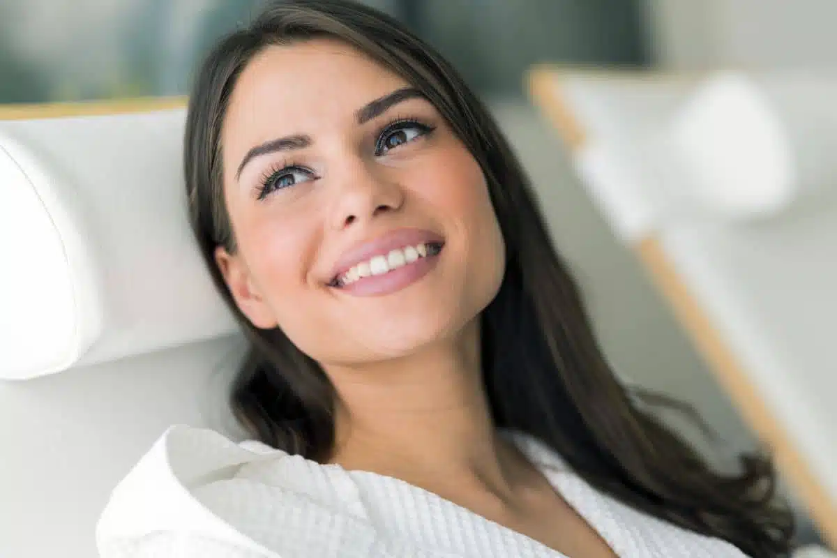 Woman smiling confidently after receiving Jeuveau treatment to smooth facial wrinkles and refresh appearance