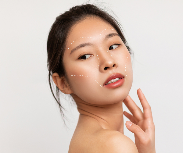 Woman with facial treatment guide lines, illustrating how Botox pairs with other procedures to improve skin and structure.