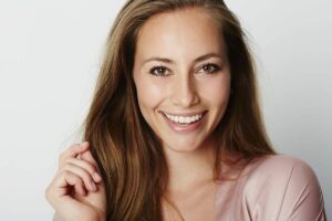 Smiling young woman with glowing skin, representing preventative Botox and skincare benefits in your 30s