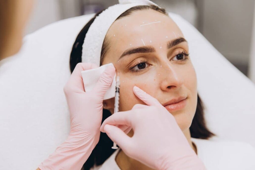 Aesthetic nurse administering Botox injections to smooth facial lines at Princeton plastic surgery practice.