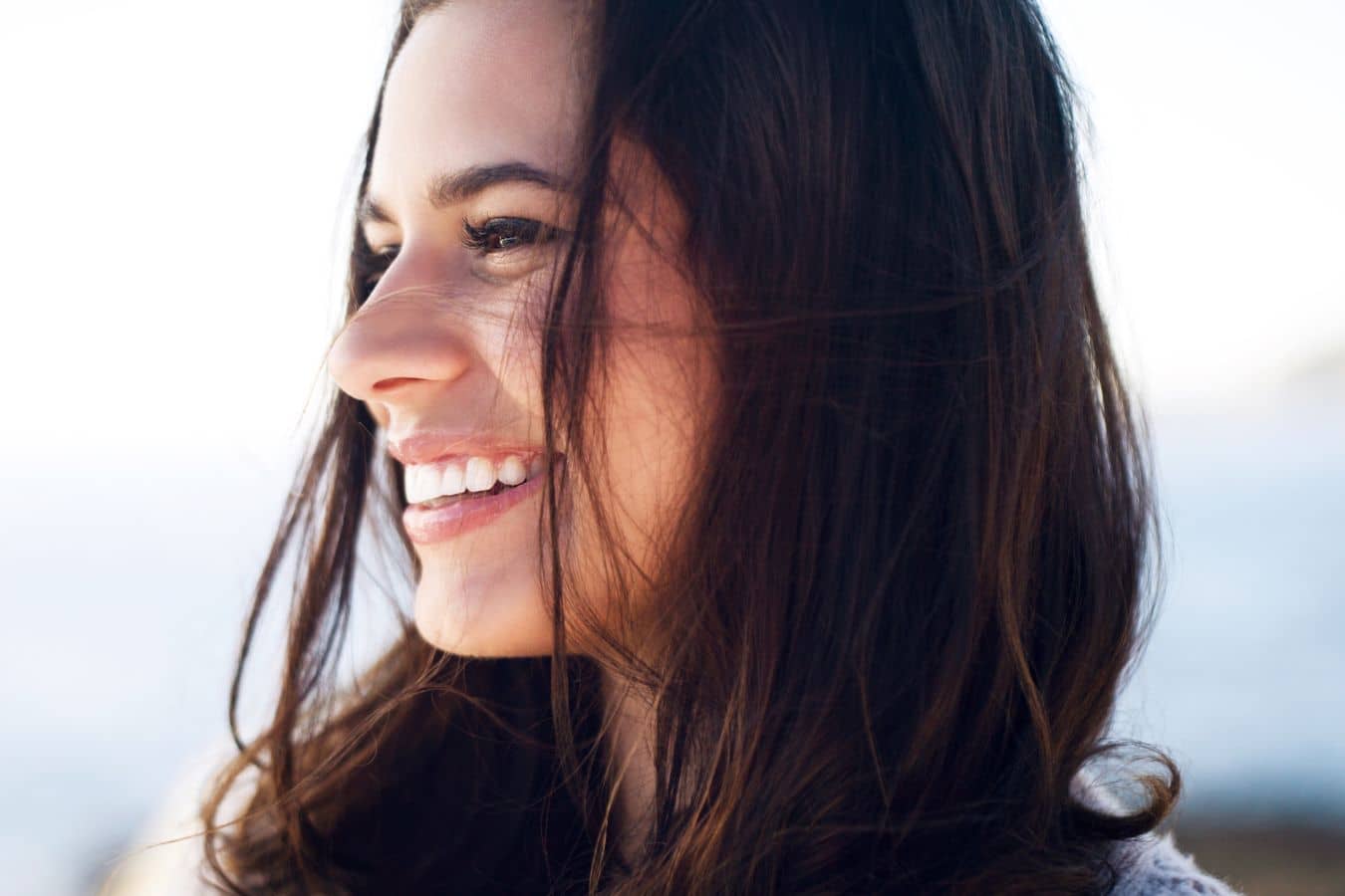 Smiling woman with smooth, natural-looking skin, representing long-lasting results from hyaluronic acid dermal fillers