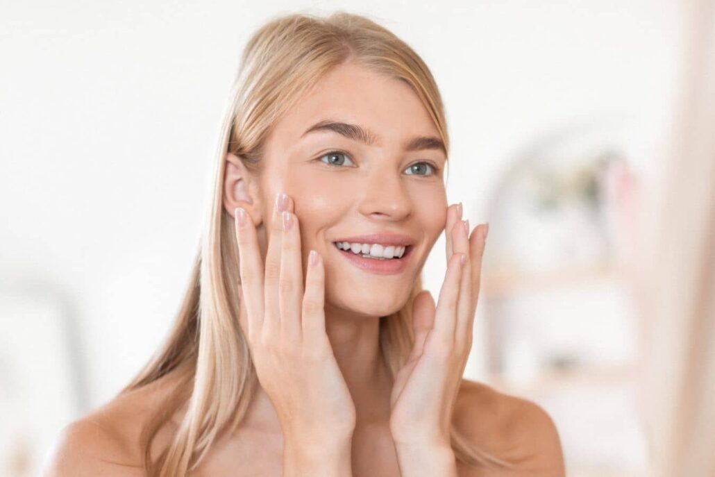 Woman with smooth, lifted cheeks and soft smile, representing long-lasting Juvederm results for facial volume and fine lines