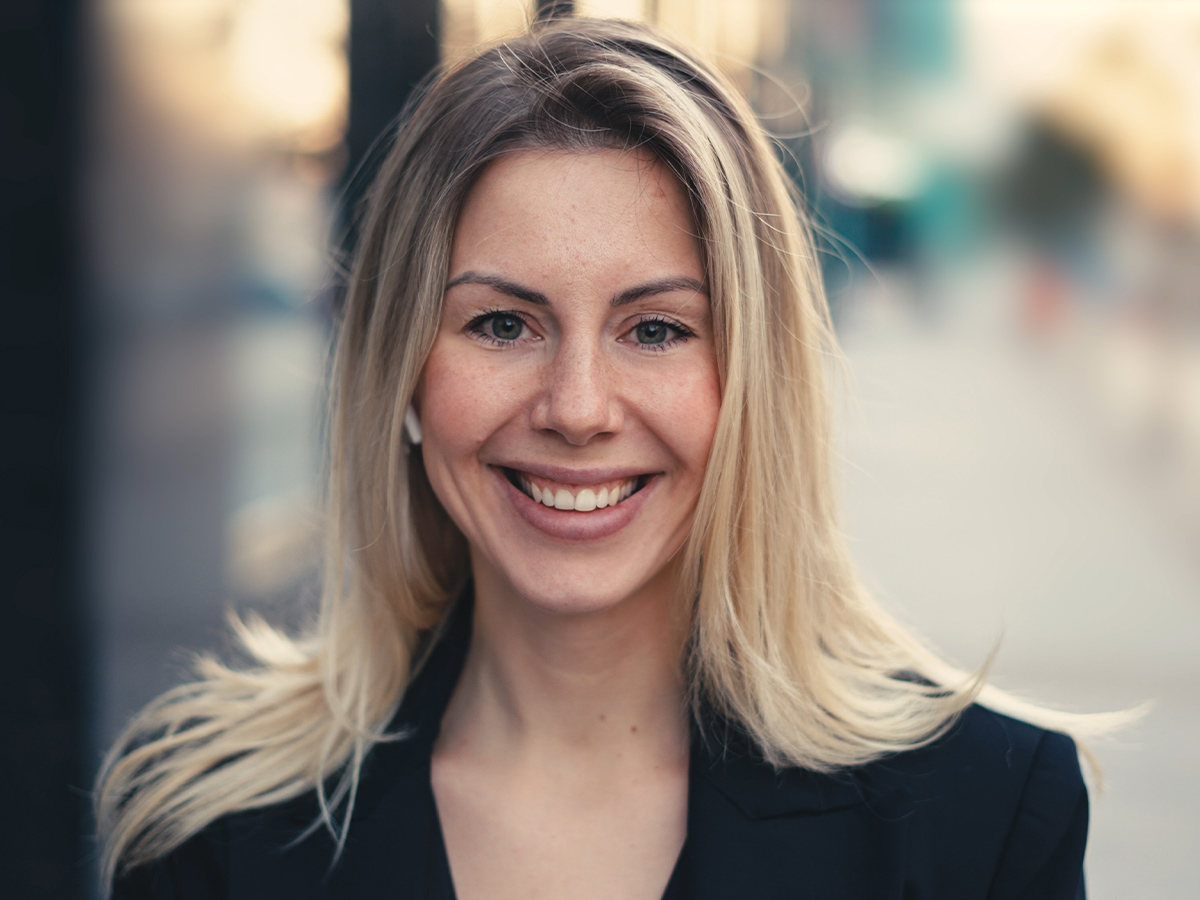 Woman with smooth skin smiling outdoors, representing Botox treatment results in New Jersey for wrinkle reduction and facial rejuvenation