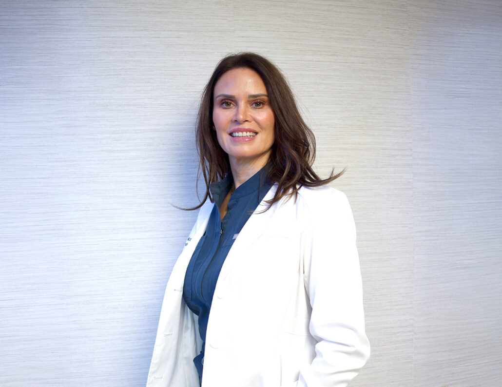 Female plastic surgeon in clinical setting representing experienced facelift specialist in New Jersey