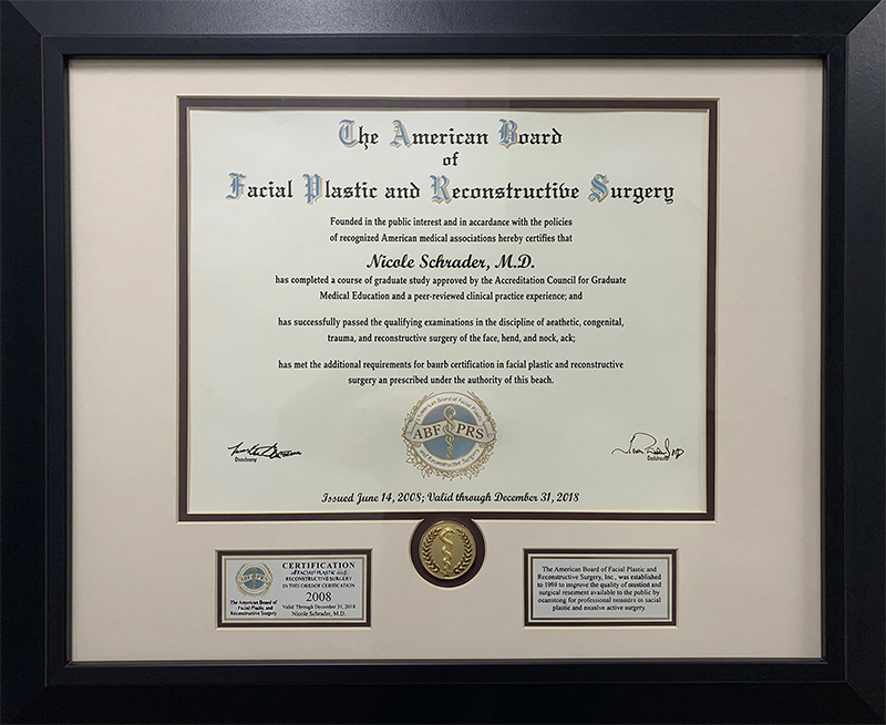 Framed medical board certification certificate for Nicole Schrader, M.D., from The American Board of Facial Plastic and Reconstructive Surgery, valid from 2008 to 2018.