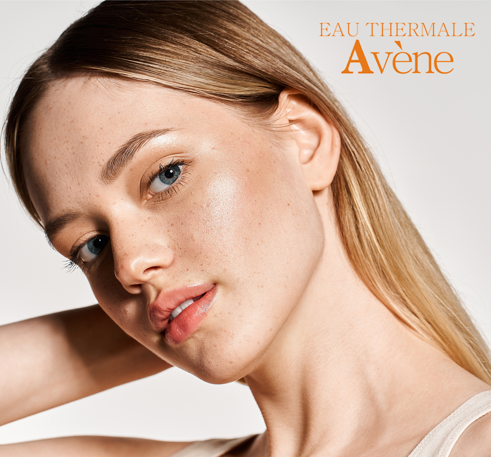Woman with glowing skin representing Avène skincare products designed for sensitive skin and dermatology-based care.