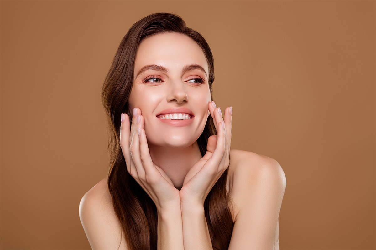 Smiling woman with clear, smooth skin illustrating balanced facial appearance after Botox treatment.