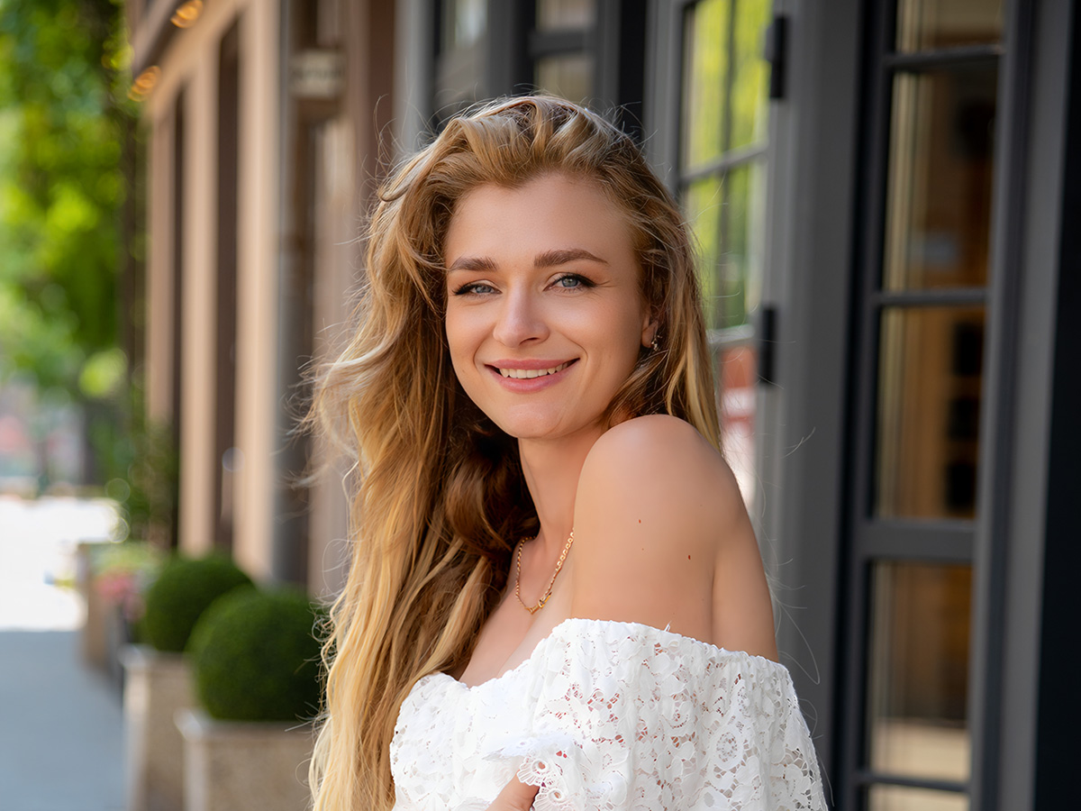 Woman with smooth, youthful skin smiling outdoors, representing natural-looking Botox results in Voorhees NJ.