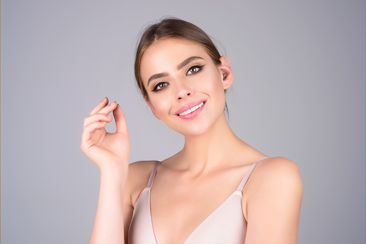 Woman with smooth forehead and lifted brows representing brow lift results and recovery in New Jersey.