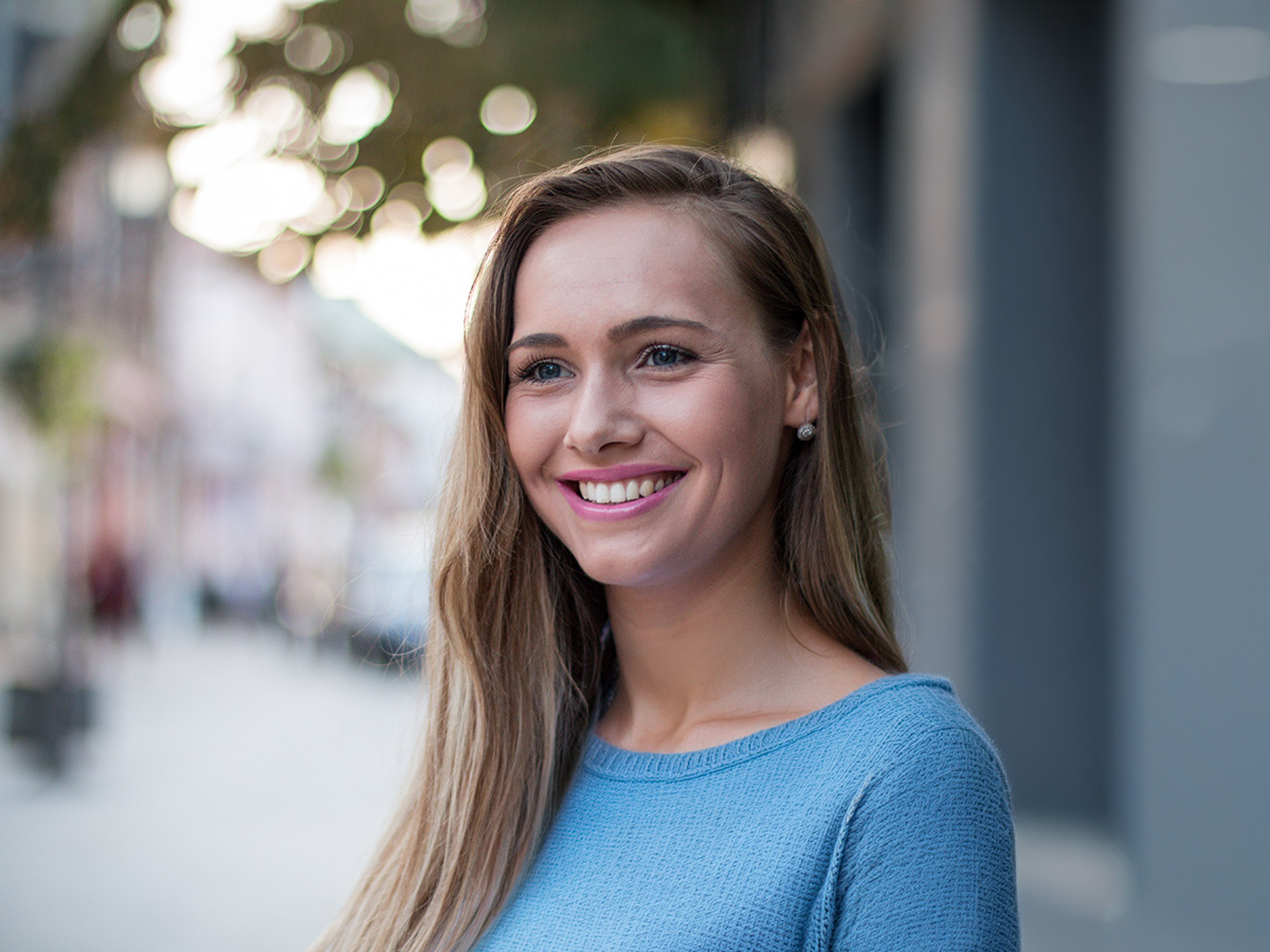 Woman with clear, glowing skin representing improved tone and texture from peels and microdermabrasion.