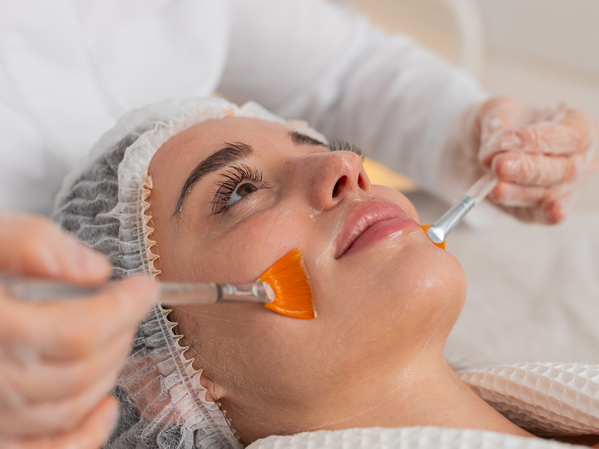 Patient receiving chemical peel treatment to improve skin texture and reveal smoother, healthier skin.