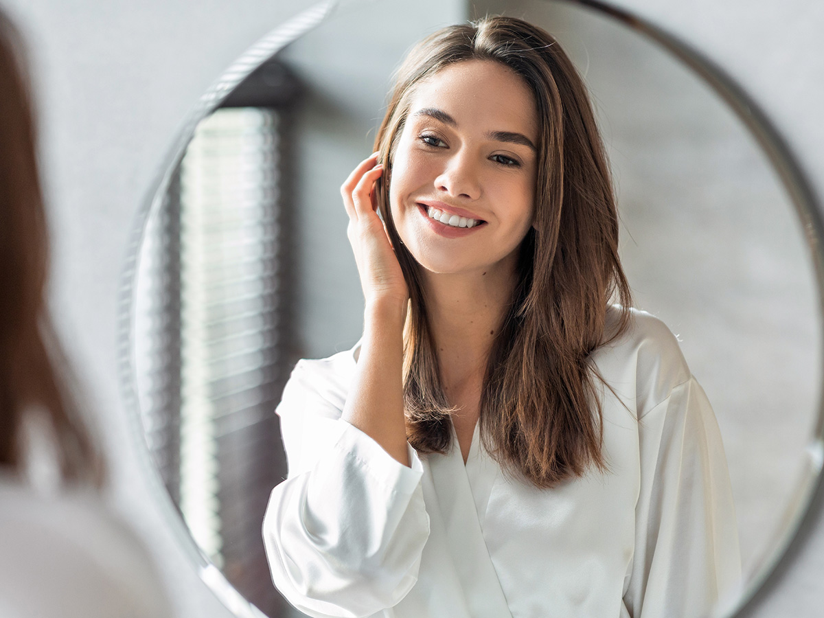 Woman with refined chin and balanced profile reflecting natural results from chin augmentation surgery.