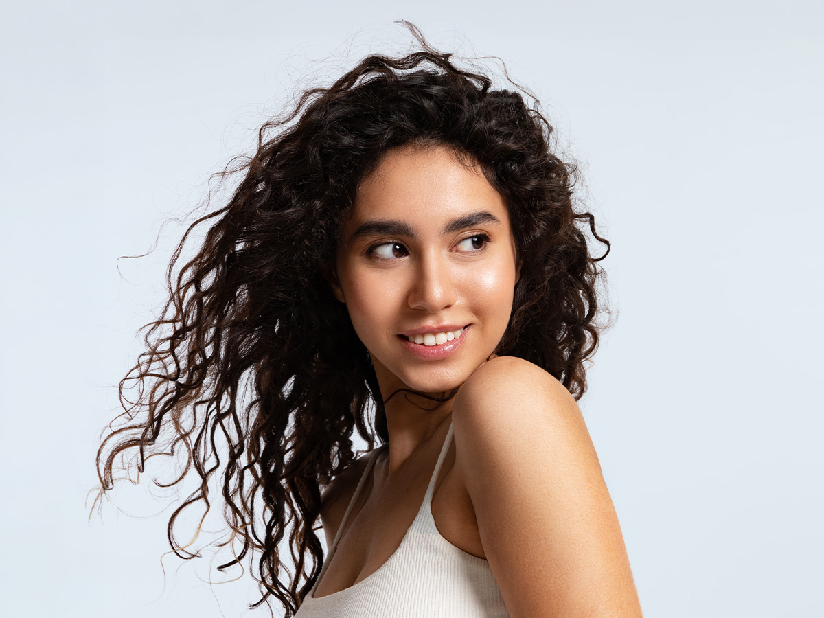 Woman with glowing, even skin tone illustrating results from Clear and Brilliant laser treatment.
