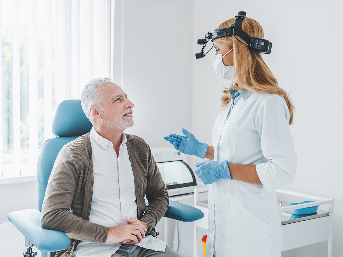 Doctor consulting patient in ENT clinic for diagnosis and treatment of ear, nose, and throat conditions.