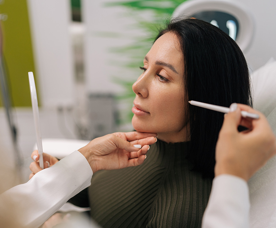 Patient consulting with specialist about facial fat grafting results and longevity in a clinical setting