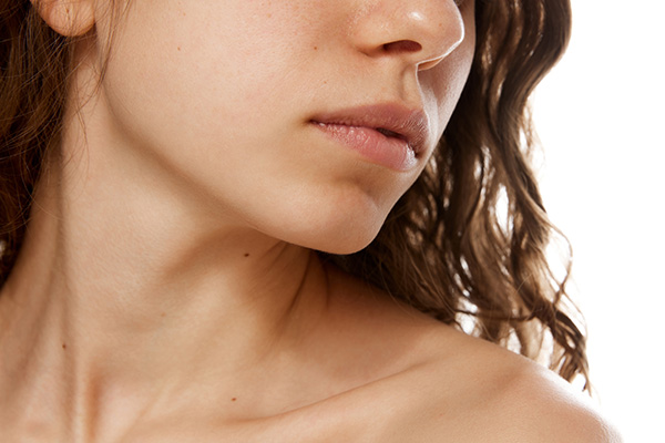Sculpted jawline with improved definition after fat reduction, enhancing facial profile and contour.