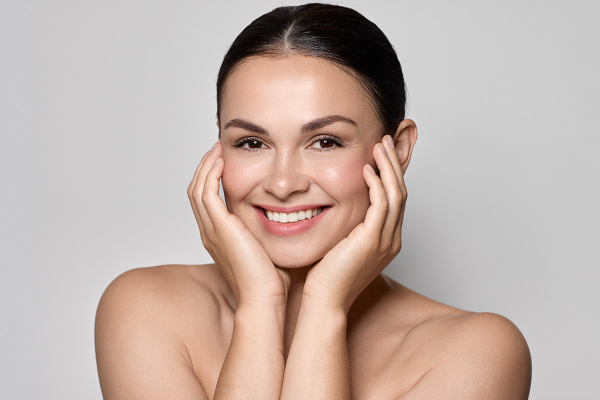 Smiling woman representing ideal Jeuveau candidates for treating forehead lines and facial aging signs in New Jersey.