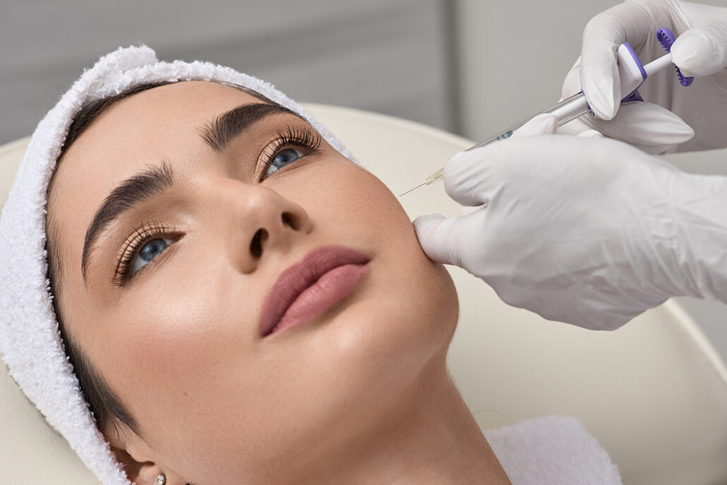 Practitioner injecting Juvederm into cheek for facial contouring and volume restoration