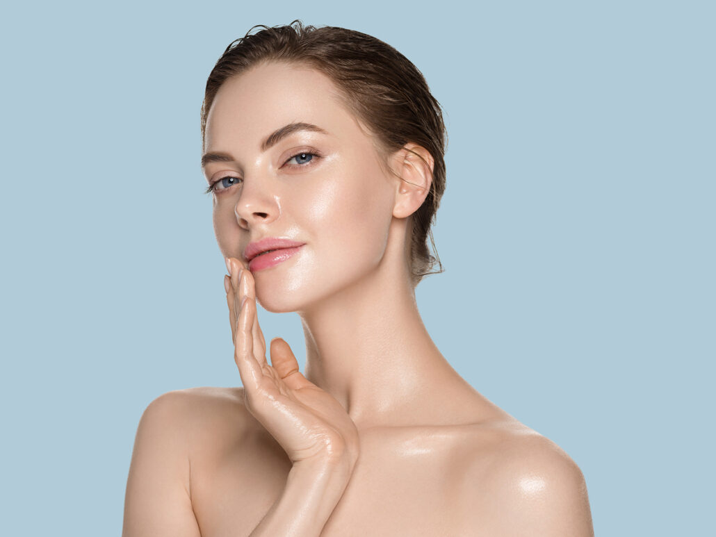 Woman touching glowing skin representing microneedling procedure, collagen stimulation, and post-treatment skin rejuvenation