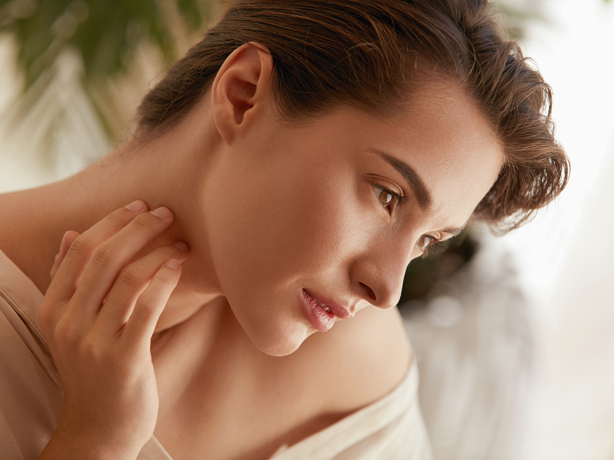 Woman touching smooth skin illustrating SkinPen microneedling benefits for acne scars, collagen boost, and skin rejuvenation in Princeton NJ