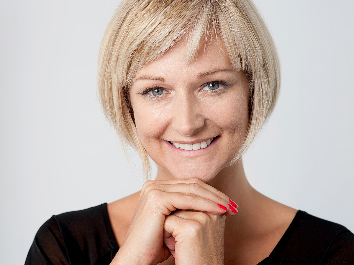 Woman with refreshed youthful face showing natural results of mini facelift procedure targeting early aging signs