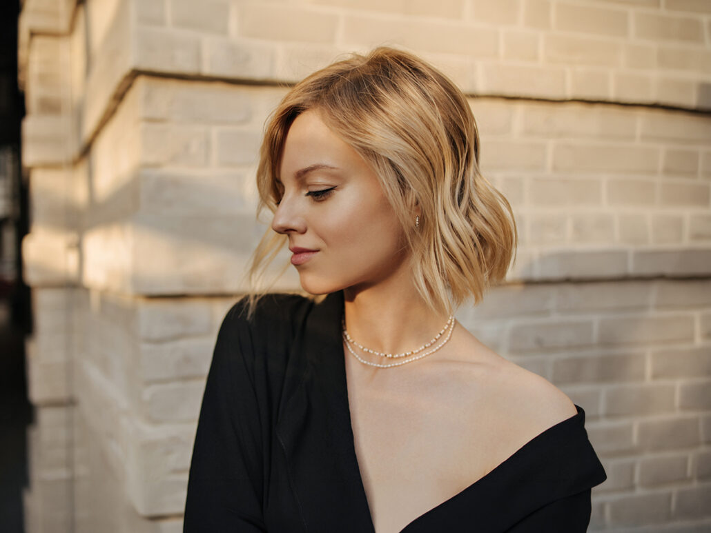 Woman with smooth, tightened neck and defined jawline after neck lift and chin liposuction in New Jersey
