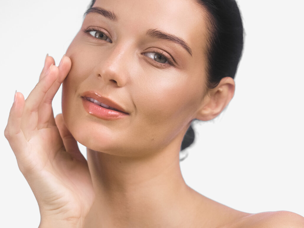 Woman with clear, smooth skin illustrating minimal downtime and mild swelling after Volbella lip filler treatment