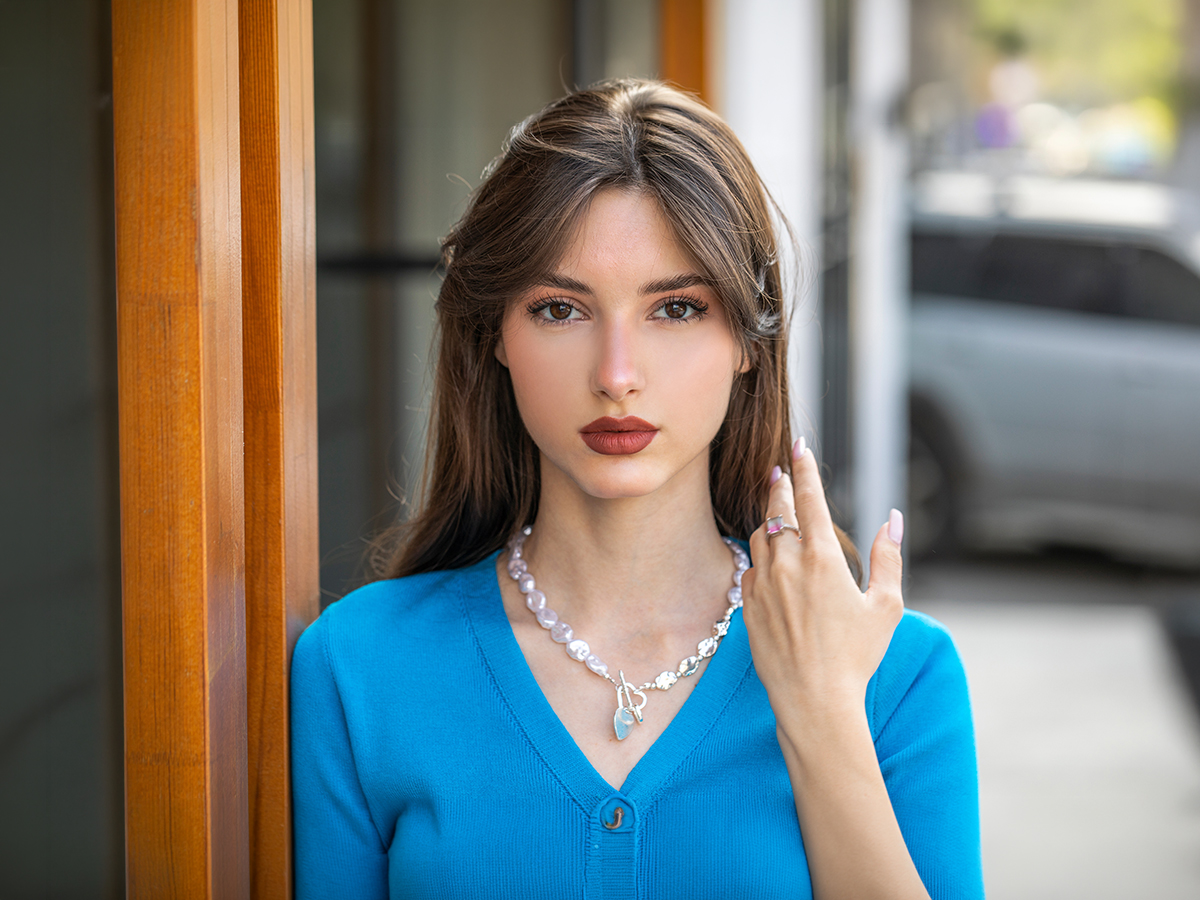 Woman in blue top near doorway for blepharoplasty in Voorhees, NJ