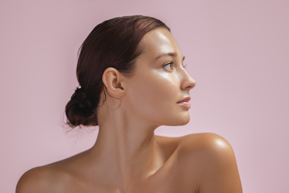 Side-profile woman beside Fractional CO2 candidate criteria for wrinkles, sun damage, acne scars, and skin texture.