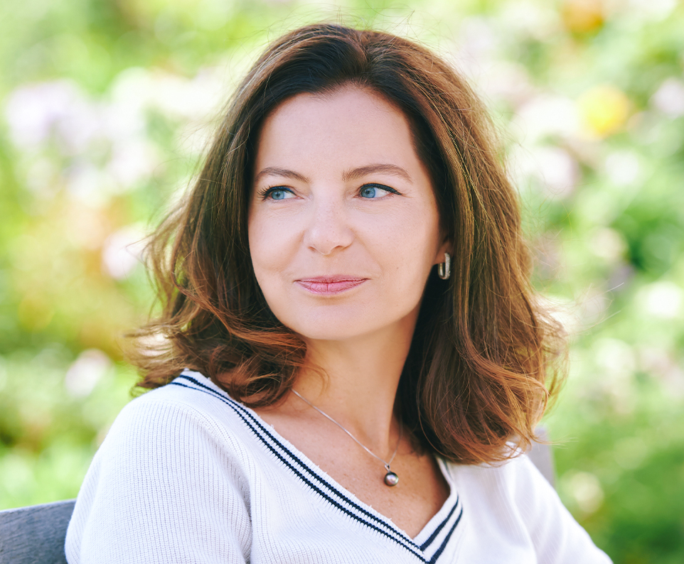 Woman outdoors representing experienced facelift surgery for natural results, precision, and patient-centered care.