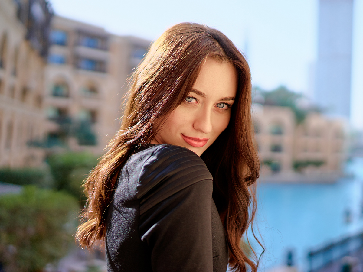 Woman outdoors representing Princeton blepharoplasty for natural eyelid surgery and rested-looking eyes.
