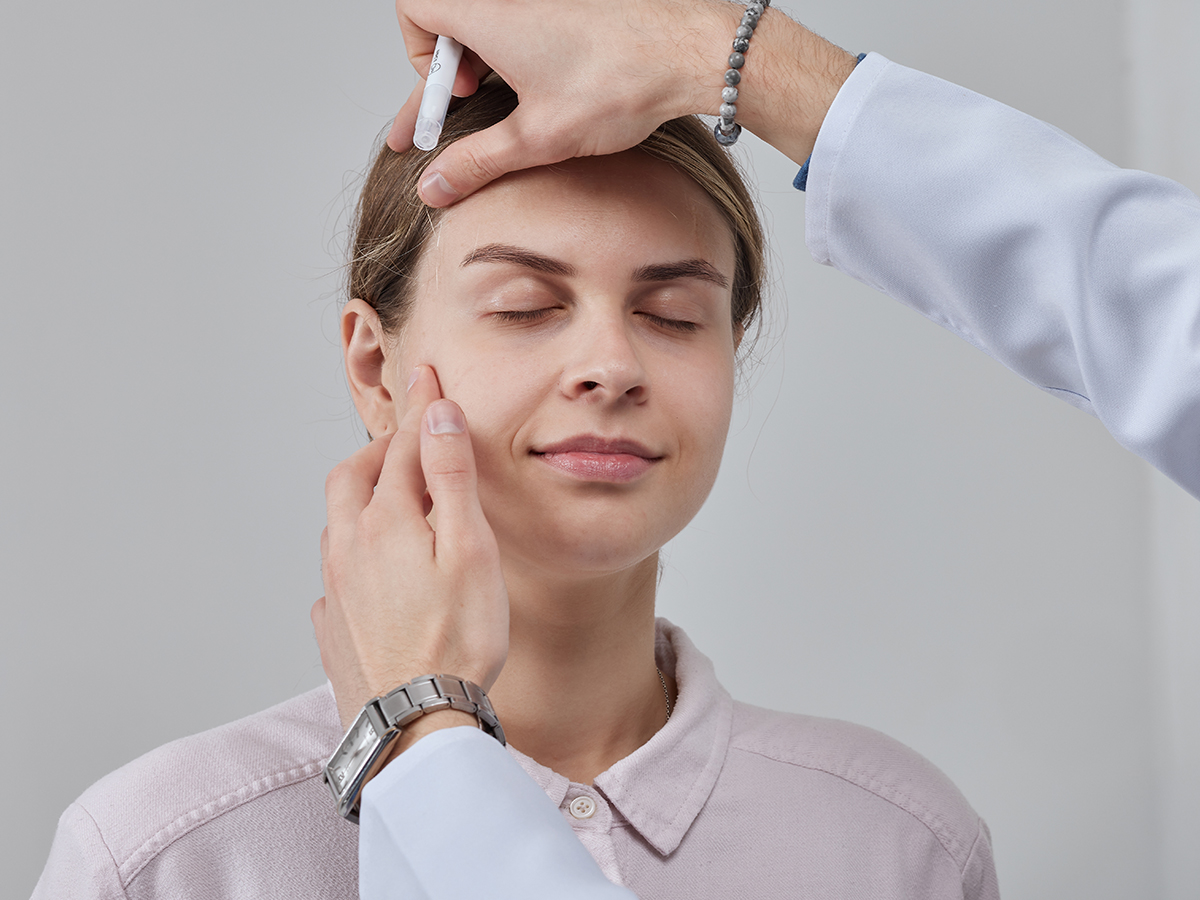Patient during eyelid consultation representing Princeton blepharoplasty options for upper and lower eyelid concerns.