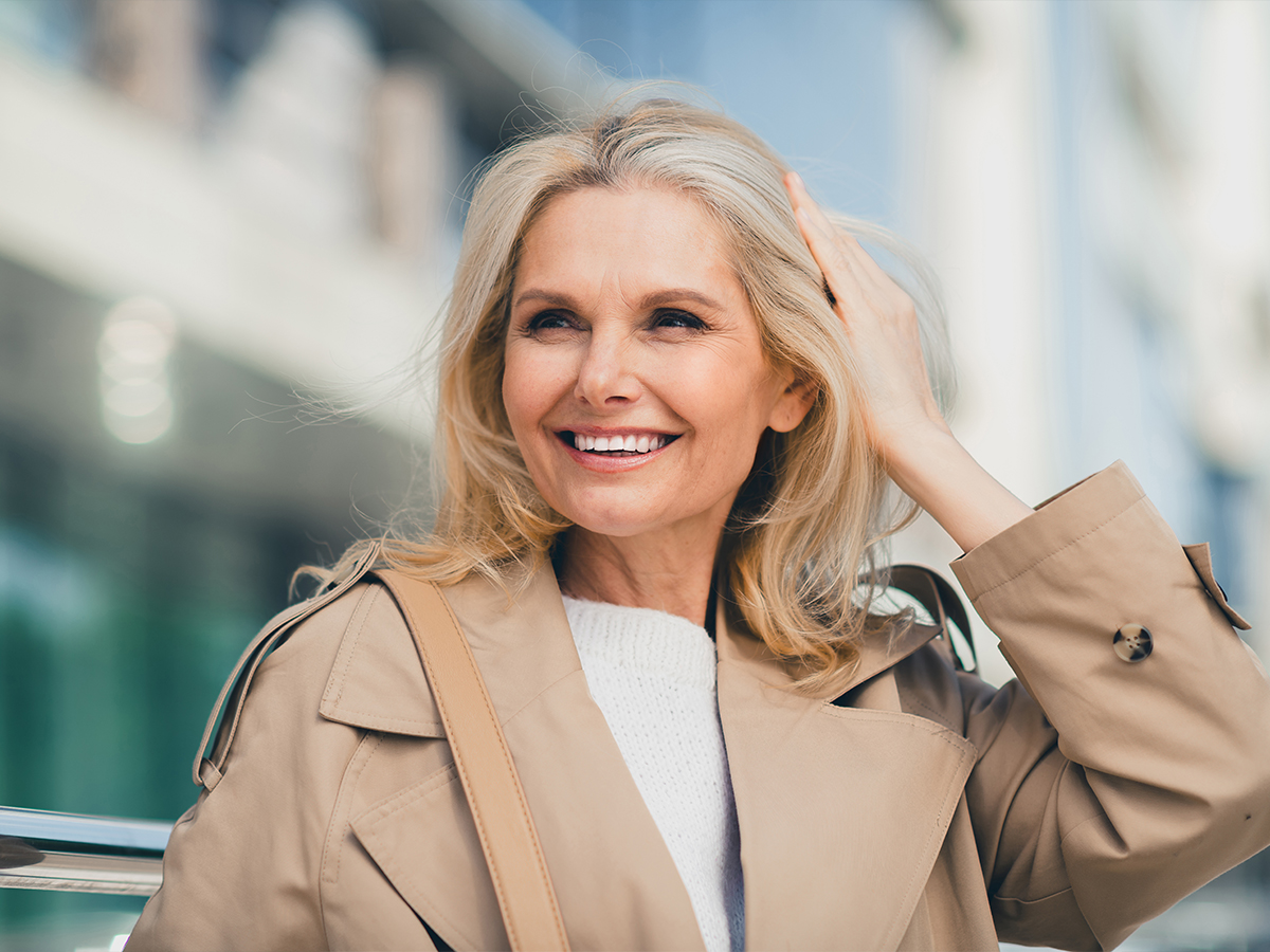 Smiling mature woman representing Princeton facelift surgery for natural facial rejuvenation and balanced results.