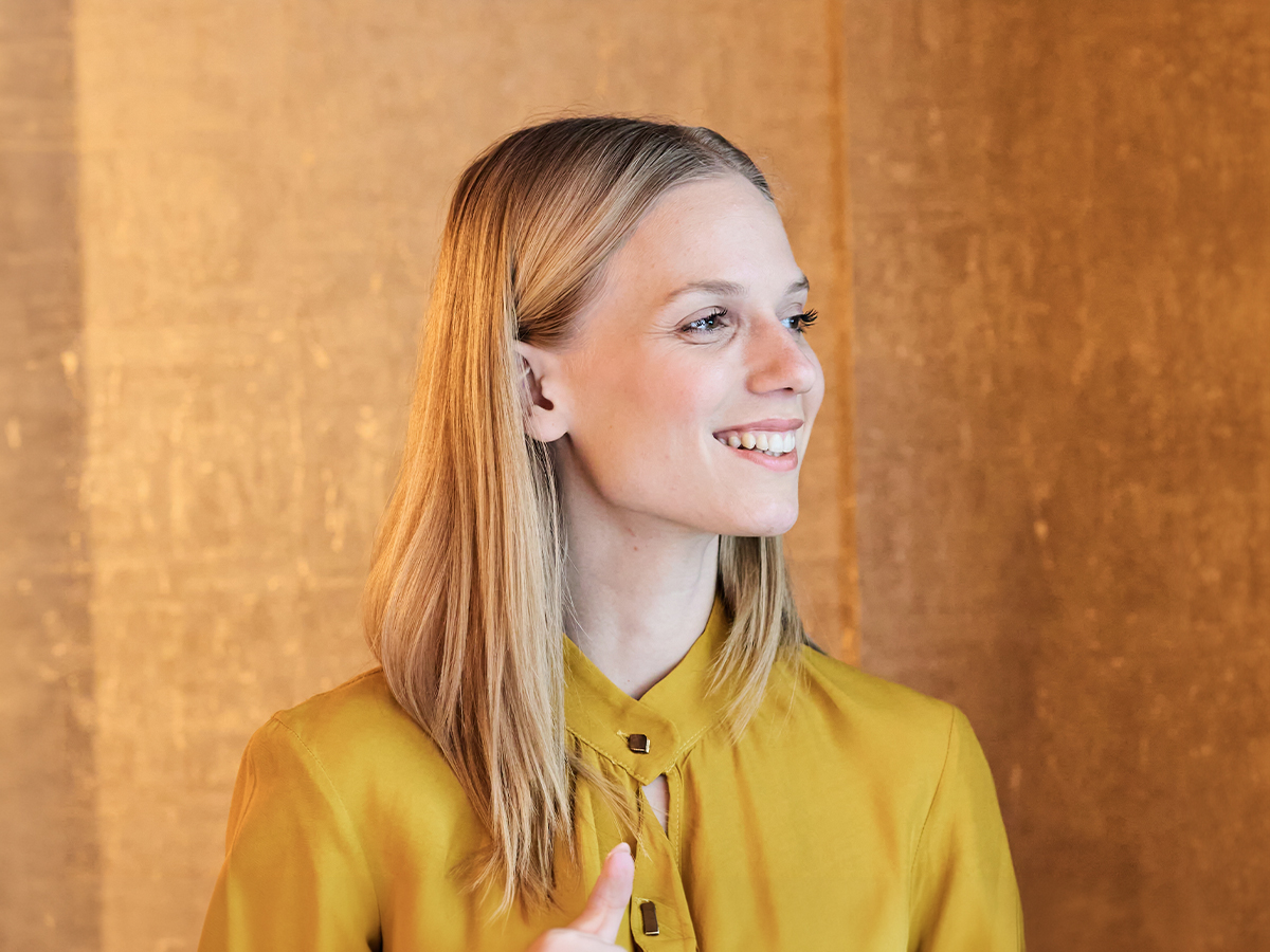 Smiling woman in profile representing Princeton rhinoplasty for natural facial balance and refined results.