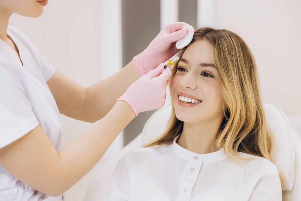 Patient receiving Botox forehead treatment to soften expression-related facial wrinkles.