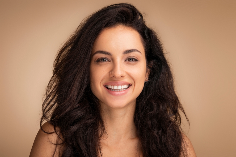 Smiling woman beside PRP and nanofat scar benefits for texture, acne scars, redness, and surrounding skin quality.