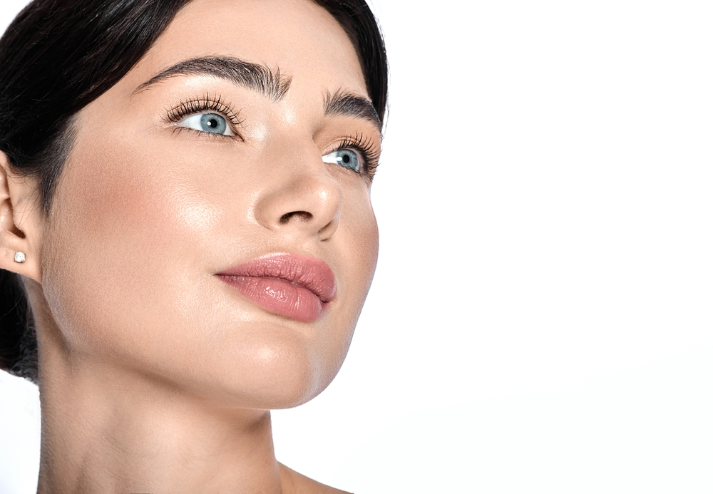 Woman beside fractional CO2 treatment steps, including consultation, preparation, treatment, and immediate aftercare.